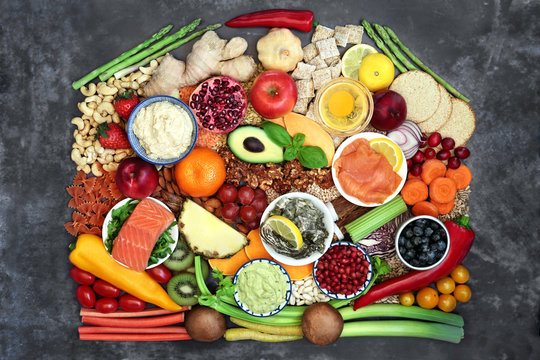 Super food for health and fitness with foods high in antioxidants, anthocyanins, vitamins, minerals, protein,  smart carbs, omega 3 and fibre. Flat lay on grunge background.