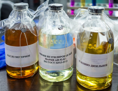 Sealed fuel samples. Translation of the inscription "Motor oil; unleaded gasoline; diesel fuel"