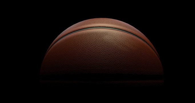 Basketball slowly rotate on black background