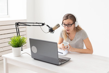 Radio host concept - Young woman working as radio host at radio station
