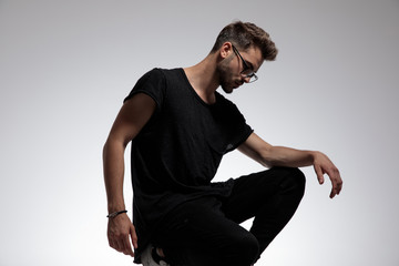 sexy fashion man dressed casual wearing glasses and posing