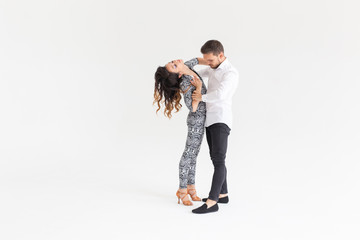 Social dance, kizomba, tango, salsa, people concept - beautiful couple dancing bachata on white...