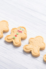 cookies in the shape of a man on a light table background, close-up