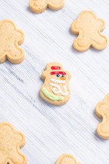 different shaped cookies on a light gray background with a cheerful snowman in the center
