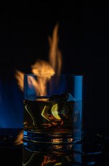 fire ice whiskey glass on a dark background