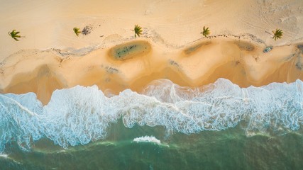 High angle shot of the beautiful foamy waves in Northern Brazil, Ceara, Fortaleza/Cumbuco/Parnaiba