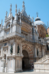 Fototapeta na wymiar Venice, Italy: The Arco Foscari is in the courtyard of the Palazzo Ducale, San Marco basilica behind it