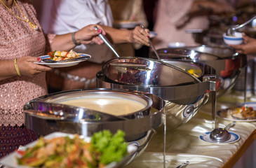 Obraz na płótnie Canvas Food Buffet Catering Dining Eating Party Sharing Concept.people group catering buffet food indoor in luxury restaurant with meat colorful fruits and vegetables