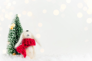 White Christmas or New Year background with Christmas tree and white rabbit