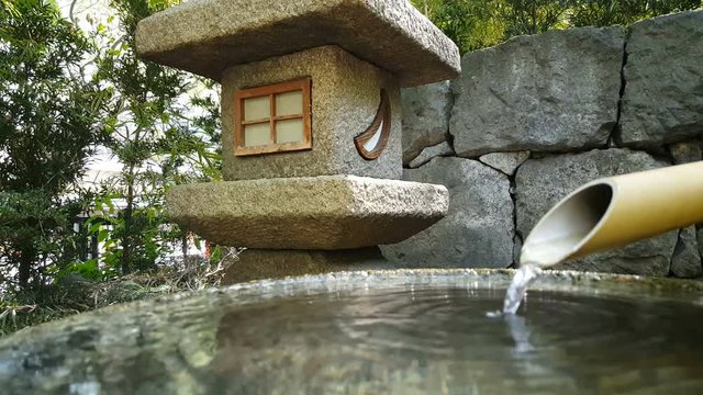 Bamboo water pipe at a pond garden
