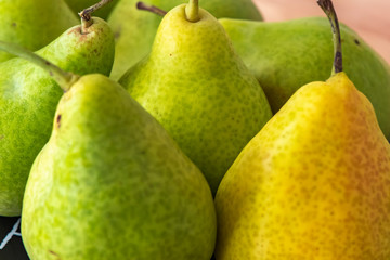 Some pears. The focus is on the pear in the background in the middle.