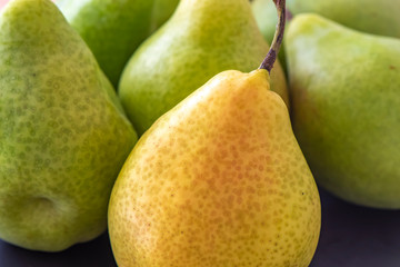 Some pears. The focus is on the pear in foreground.