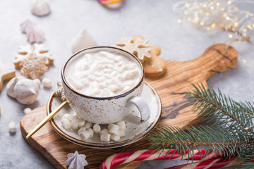 Obraz na płótnie Canvas Hot chocolate cacao drinks with marshmallows in Christmas white mug on grey background. Traditional hot beverage, festive cocktail at X-mas or New Year