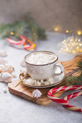 Hot chocolate cacao drinks with marshmallows in Christmas color mug on grey background. Traditional hot beverage, festive cocktail at X-mas or New Year