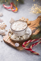 Hot chocolate cacao drinks with marshmallows in Christmas color mug on grey background. Traditional hot beverage, festive cocktail at X-mas or New Year