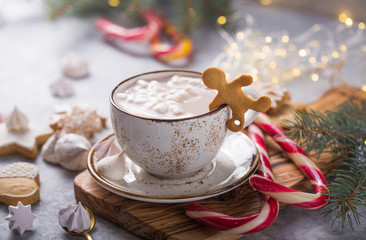 Hot chocolate cacao drinks with marshmallows in Christmas mugs on grey background. Traditional hot...