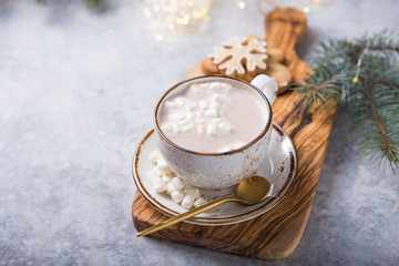 Hot chocolate cacao drinks with marshmallows in Christmas mugs on grey background. Traditional hot beverage, festive cocktail at X-mas or New Year