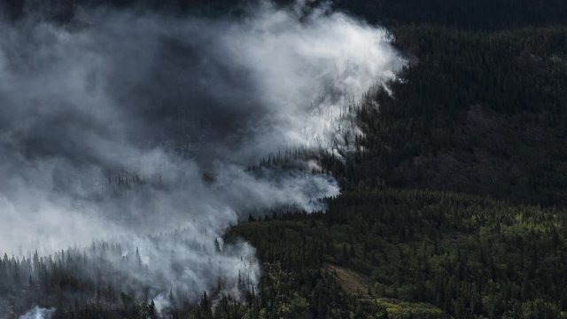 Forest fires burning in the mountains of Northern BC 4K timelapse
