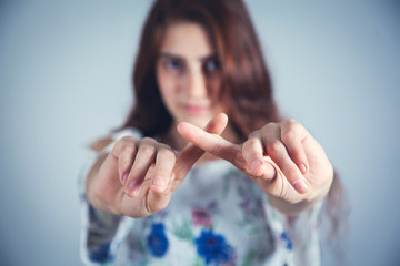 young girl finger cross sign