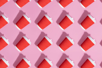 Pattern of paper cups on pink background.