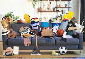 Large leather sofa with a bunch of different things - obrazy, fototapety, plakaty