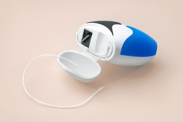 Dental floss on pastel background