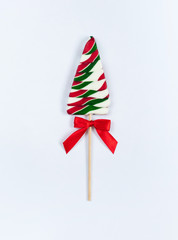 Christmas Lollipop with red bow on white background. Lollipop in the shape of a Christmas tree.