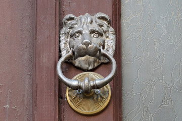  antique metal door handle in the shape of a lion's head
