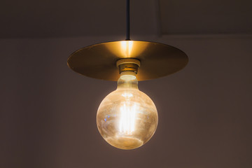 Hanging old retro style lamp with a big light bulb