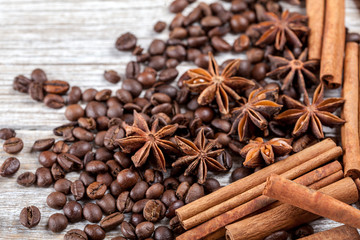 Star anise, cinnamon and roasted coffee beans. Aromatic spices on wooden background. Top view....