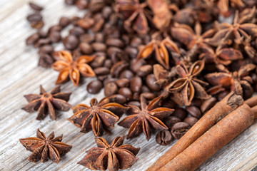 Star anise, cinnamon and roasted coffee beans. Aromatic spices on wooden background. Top view....