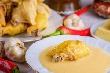 Caucasian cuisine. Circassian (Adyghe) traditional folk dish. Boiled chicken with sour cream sauce (djedlibje) Served with pasta (millet dish)