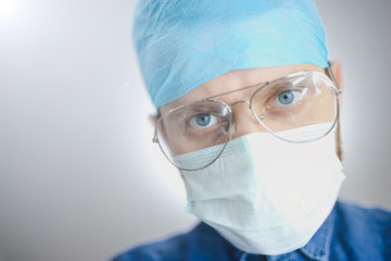 bottom view of a young surgeon looking at camera. Surgical operation in the hospital.