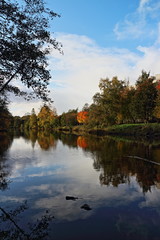 Fototapeta na wymiar the sky is reflected in a beautiful autumn landscape