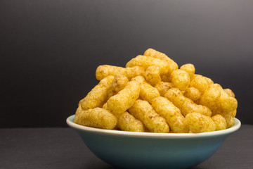 healthy snack - heap of corn puffs with quinoa and peanuts in a bowl