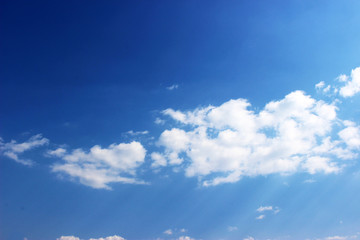 Naklejka na ściany i meble Blue sky with white clouds background. Fantastic soft white clouds against the blue sky.