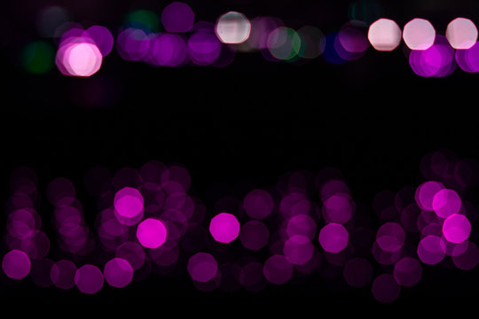 abstract unfocused purple bokeh from garland illumination on black background simple pattern concept picture 