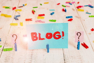Text sign showing Blog. Business photo showcasing regularly updated website web page run by individual or group Scribbled and crumbling sheet with paper clips placed on the wooden table