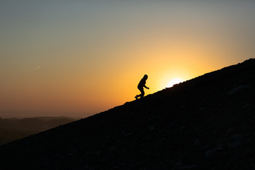 A man running uphill at sunrise