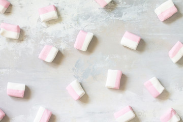 Marshmallows marshmallows isolated on light gray stone background. Top view flat lay background.