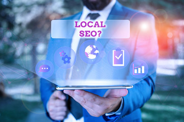 Writing note showing Local Seoquestion. Business concept for incredibly effective way to market your local business online Male human wear formal suit presenting using smart device