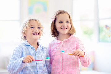 Child brushing teeth. Kids with toothpaste, brush.