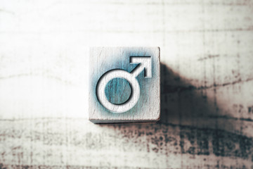 Gender Sign For Male On A Blue Wooden Block On A Table