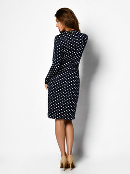 Young beautiful woman posing in new casual fashion polka-dot dress full body