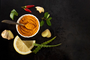 Fototapeta na wymiar Natural ingredients for colds and flu care on a white background: red pepper, garlic, ginger, aloe vera, lemon, turmeric