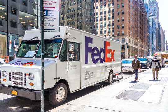 NEW YORK, USA - MAY 15, 2019: FedEx Express truck in midtown Manhattan. FedEx is one of leading package delivery services offering many different delivery options