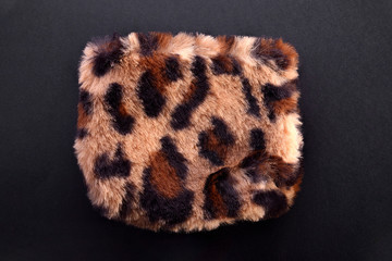Female fashion leopard purse on black background