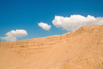 Fototapeta na wymiar Sand mountain against the blue sky