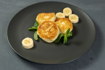 Cottage cheese pancakes on a dark plate