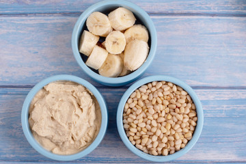 ingredients for making smoothies in bowls - banana, hummus and pine nuts